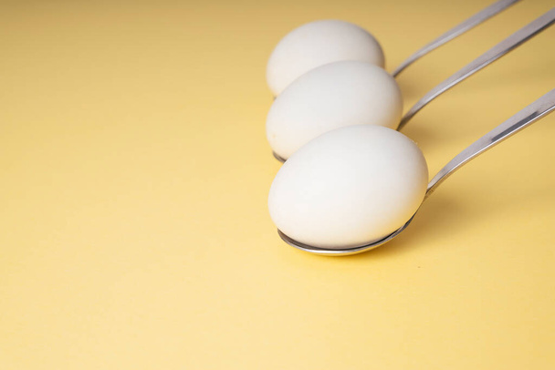  Three spoon and white egg over white background. Copy space. - Zdjęcie, obraz