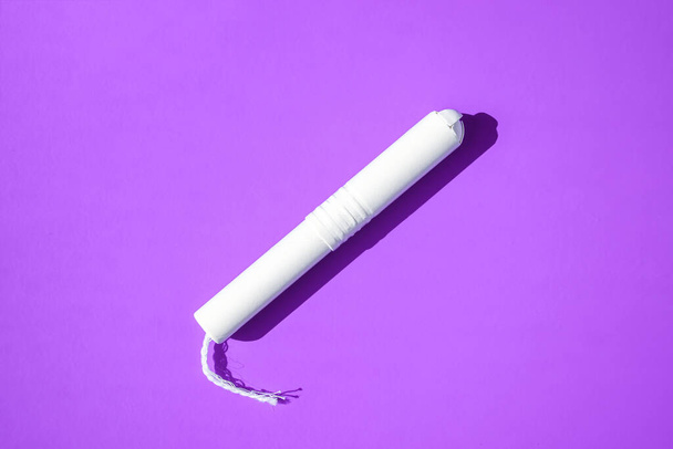 Hygienic tampons on a blue and purple background. copy space, Menstruation sanitary tampon for woman hygiene protection. Critical days. Medical conception - Photo, Image