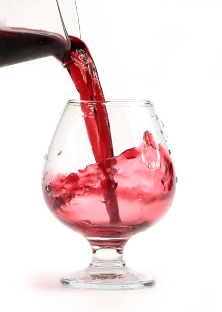 a stream of red wine fills the glass - Photo, image