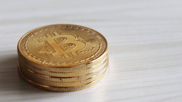 A stack of bitcoin on the wood background. - Zdjęcie, obraz