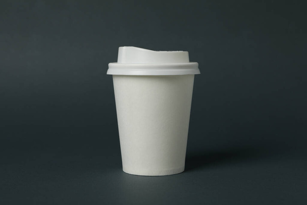 White paper cup on light black background, space for text - Fotografie, Obrázek