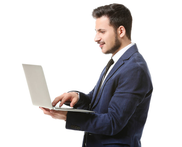 Handsome young businessman with laptop on white background - Photo, Image