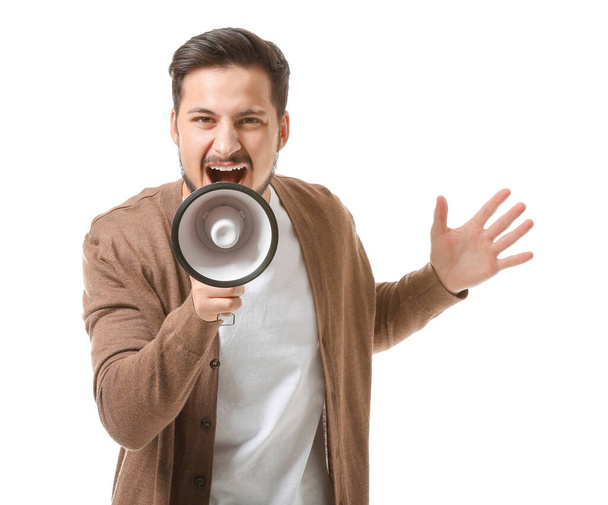 Emotional young man with megaphone on white background - Фото, зображення
