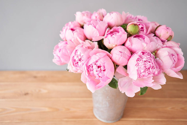 Flowers delivery. Pink Angel Cheeks peonies in a metal vase. Beautiful peony flower for catalog or online store. Floral shop concept . Beautiful fresh cut bouquet. - Fotografie, Obrázek