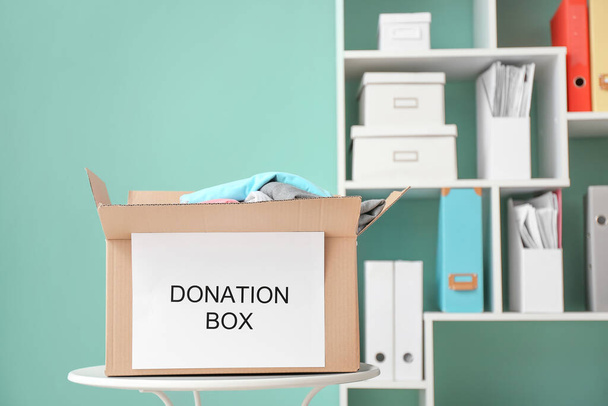 Box with donations on table - Foto, imagen