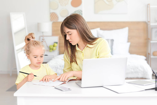 Working mother with her little daughter at home - Photo, Image