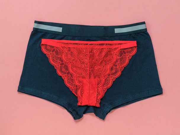 Blue men's and red women's underpants on a red background. - Photo, Image