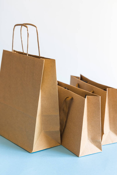 Zero waste shopping concept, kraft brown paper bags on blue white background.  - Photo, Image