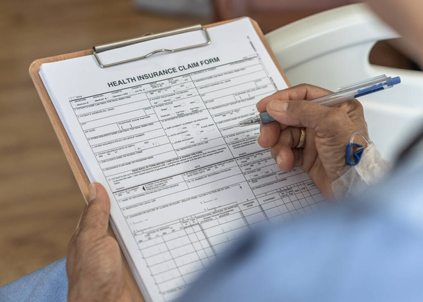 Health insurance claim form application for medicare coverage and medical treatment for patient with illness, accident injury and admitted in hospital ward - Foto, imagen