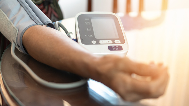 Elderly patient with bp, heart rate, digital pulse check equipment for medical geriatric awareness in stroke systolic high blood pressure, hypertension, hypotension and cardiovascular disease in aged senior older woman person - Photo, Image