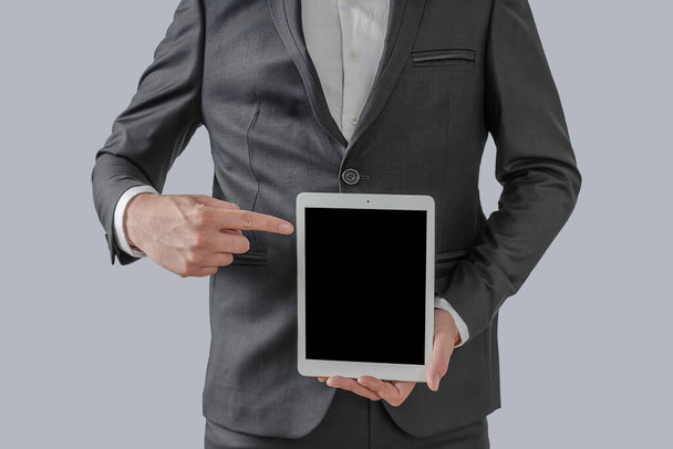 Businessman hand holding tablet with blank on screen display  - Fotoğraf, Görsel
