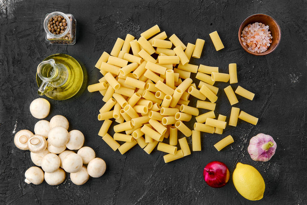 Overhead view of rigatoni pasta on black background - Foto, Imagem