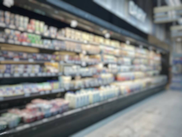 Market store or marketplace shopping blur background of supermarket indoor grocery retail shop with blurry food products and diary supplies on shelves in aisle - Photo, Image