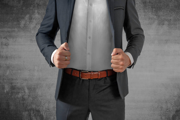 Close up of businessman in suit over dark concrete texture - Фото, изображение