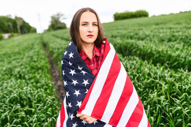 Serious young woman with american flag - Fotó, kép