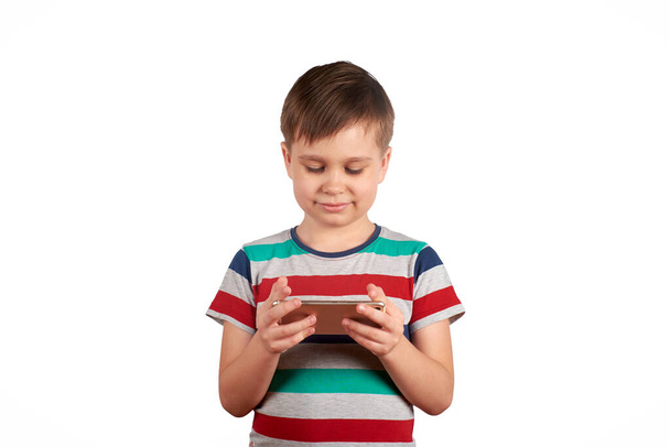 Little kid playing games on smartphone isolated over white background - Foto, Bild