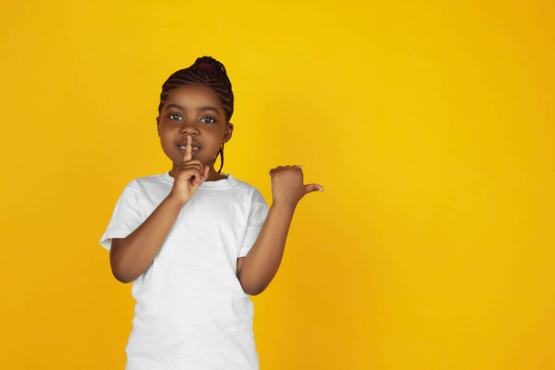 Little african-american girls portrait isolated on yellow studio background - Fotografie, Obrázek