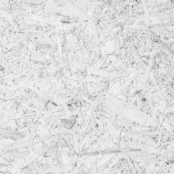 Tablero aglomerado, tablero de filamento orientado a OSB partícula prensada fondo de panel de madera reciclada con fondo de patrón de fibra de madera granulada en color gris blanco natural - Foto, Imagen