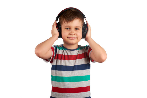 Adorable cute child enjoying favorite songs using wireless headphones. isolated on white background. Leisure, music and entertainment concept. - Foto, Imagem