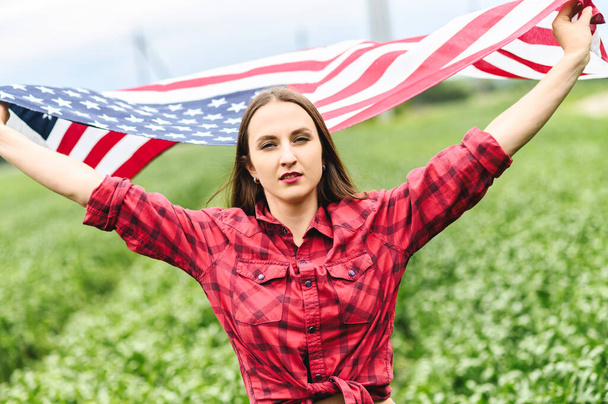 Woman is running through the field with USA flag - Fotó, kép