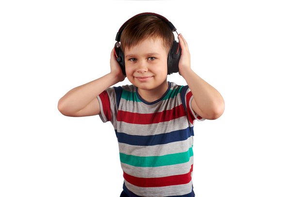Adorable cute child enjoying favorite songs using wireless headphones. isolated on white background. Leisure, music and entertainment concept. - Fotografie, Obrázek
