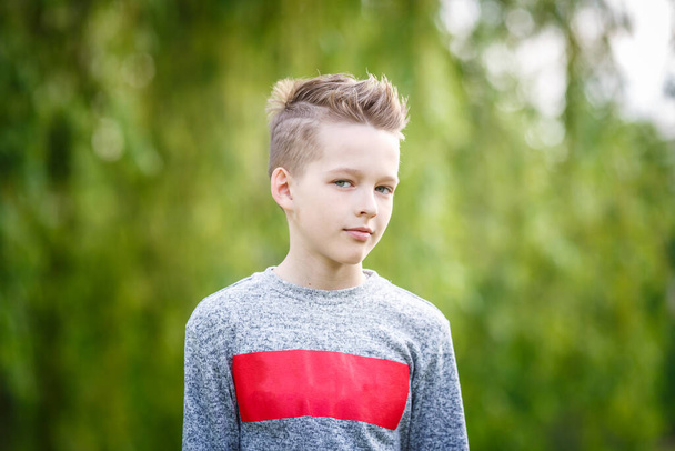 close up portrait of handsome boy teenager in green background - Photo, image