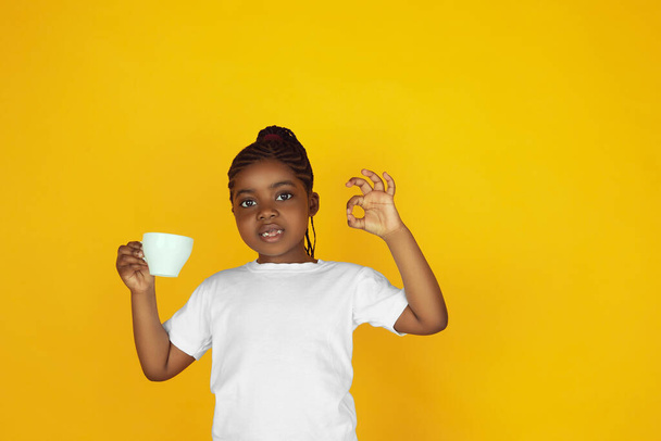 Little african-american girls portrait isolated on yellow studio background - Fotografie, Obrázek
