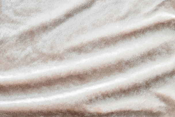 Beige gold velvet background or velour flannel texture made of cotton or wool with soft fluffy velvety satin fabric cloth metallic color material - Photo, Image