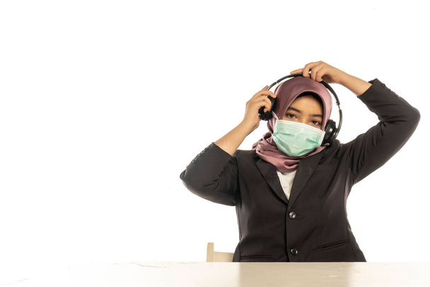 Business Lifestyle, Cute Malay Woman wearing hijab, face mask and headset - Photo, Image