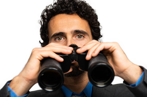 Businessman looking through binoculars isolated on white - Photo, Image