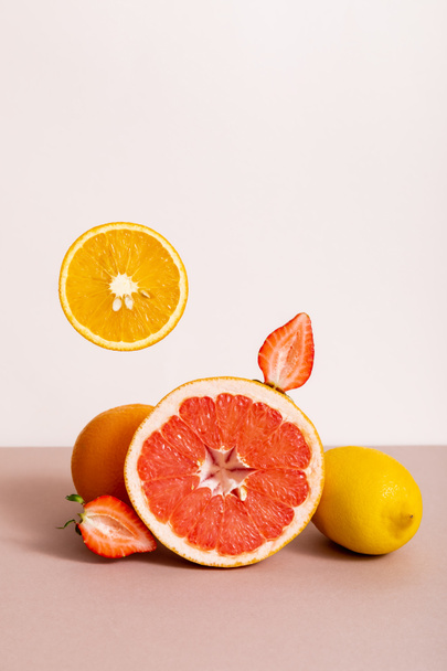 fruit composition with citrus fruits and strawberry isolated on beige - Photo, Image