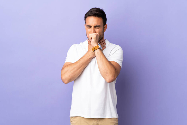 Young handsome man isolated on purple background coughing a lot - Photo, Image