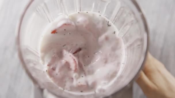 fresh homemade milkshake from strawberries, milk and chia seeds in glass bowl  - Záběry, video