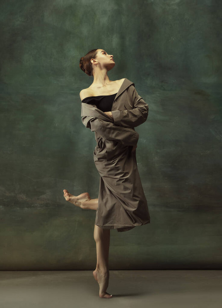 Young graceful tender ballerina on dark studio background - Φωτογραφία, εικόνα