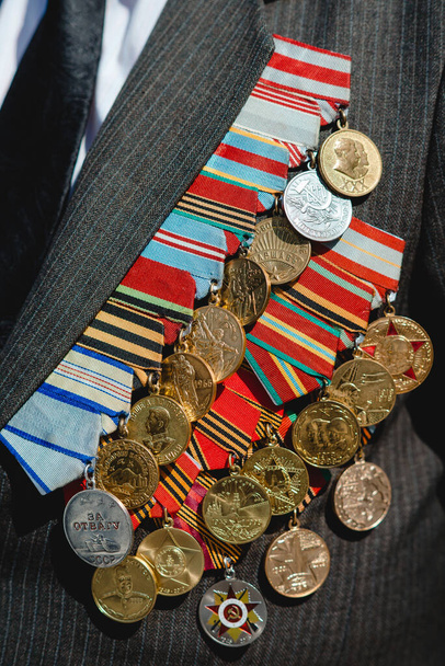 Victory Day. Orders and medals on the chest of a veteran. Close-up.  - Фото, зображення