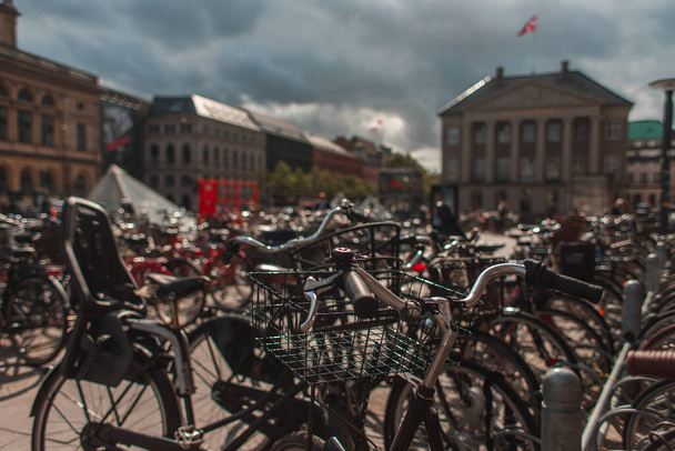 Selective focus of bicycles with sunlight on urban street in Copenhagen, Denmark  - Photo, Image