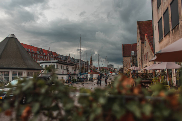COPENHAGEN, DENMARK - APRIL 30, 2020: Selective focus of urban street with cloudy sky at background  - Zdjęcie, obraz