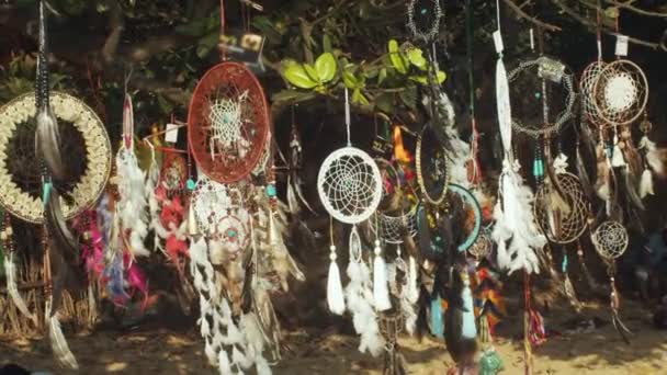 Güzel Renkli Rüya Yakalayıcılar markette ağaçta asılı duruyor. Boho 'daki güzel el yapımı dekorasyonlar ve Kuzey Amerika kabilesi stili dallara tutunup rüzgarda sallanıyor. Hediyelik Eşya Sokağı Pazarı  - Video, Çekim