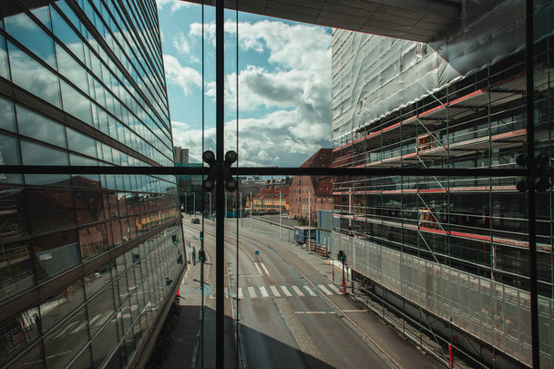 COPENHAGEN, DENMARK - APRIL 30, 2020: Exterior of Black Diamond Royal Library with urban street and cloudy sky at background, Copenhagen, Denmark  - Φωτογραφία, εικόνα