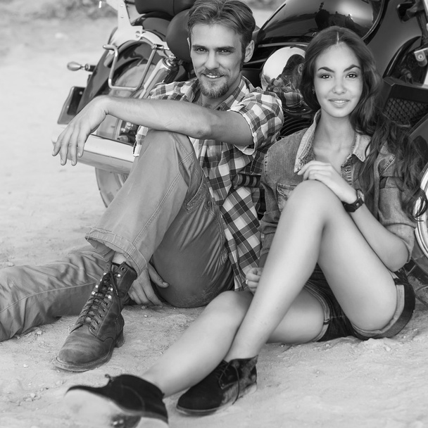 Two people and bike - fashion woman and man sitting by motorbike - Фото, изображение