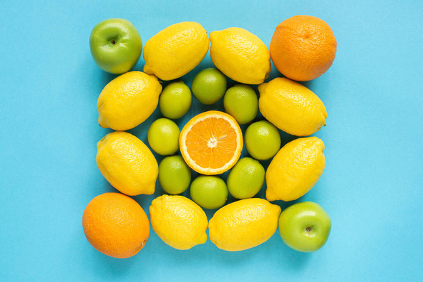 top view of fresh fruits on blue background - Fotó, kép