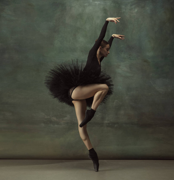 Young graceful tender ballerina on dark studio background - Fotografie, Obrázek