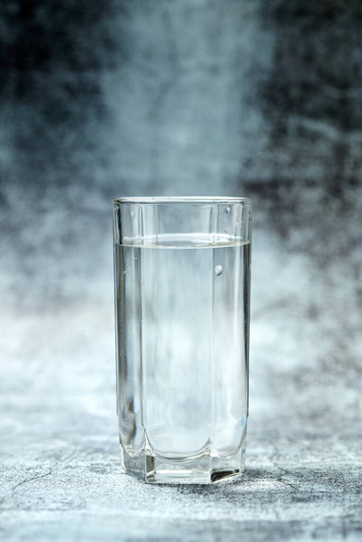 Glass of sparkling water on grey background, close view - Photo, Image