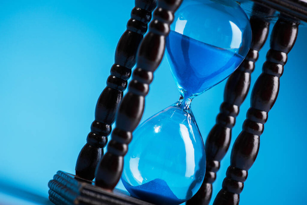 close up of hourglass on a blue background - Photo, Image