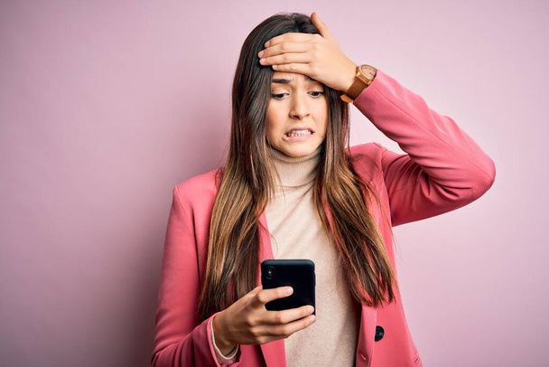 Young beautiful girl having conversation using smartphone over white background stressed with hand on head, shocked with shame and surprise face, angry and frustrated. Fear and upset for mistake. - Foto, Bild
