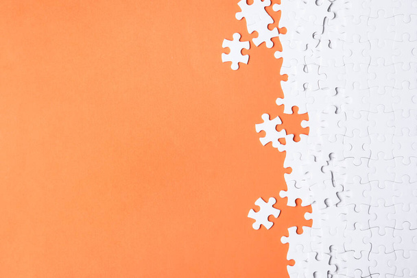 Blank white puzzle pieces on orange background, flat lay. Space for text - Foto, immagini