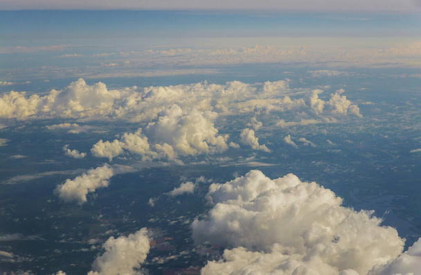 Cloud top aerial view of blue sky beautiful natural landscape from airplane window. - Photo, Image