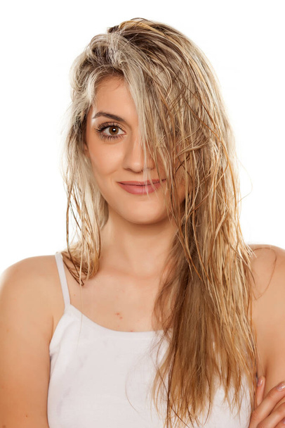 smiling blond woman with wet hair on white background - Photo, Image