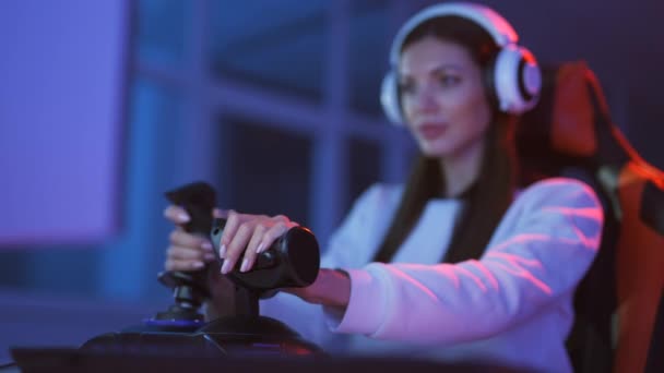 The gamer girl with headphones plays video games - Footage, Video