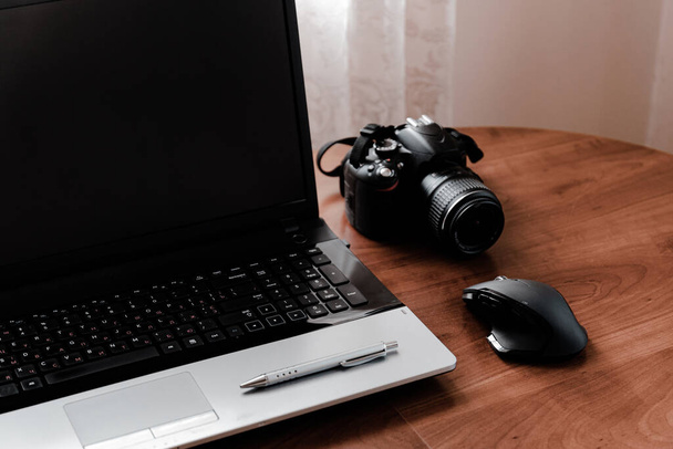 Working space of Photographer or Designer which including of dslr camera lens and wireless mouse on wood desk. Smart Phone, Smart Watch, computer and mouse, tablet for professionals photographer. - Foto, Imagen